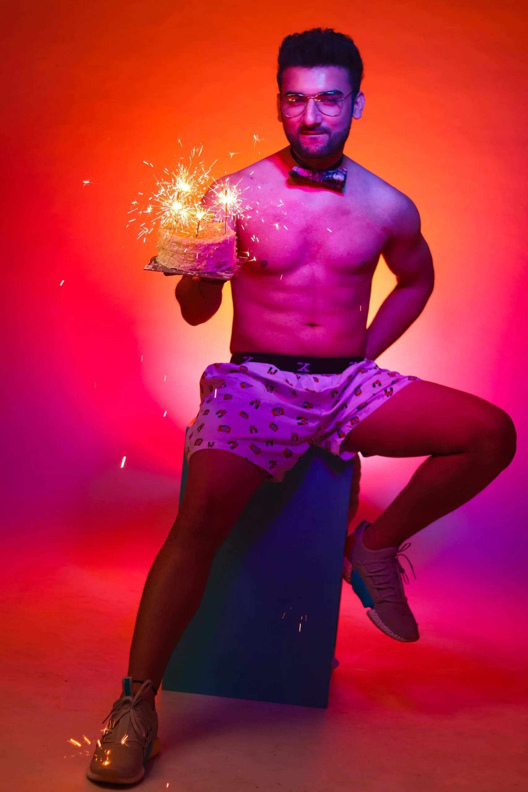 A vibrant portrait of a man celebrating with a sparkler.