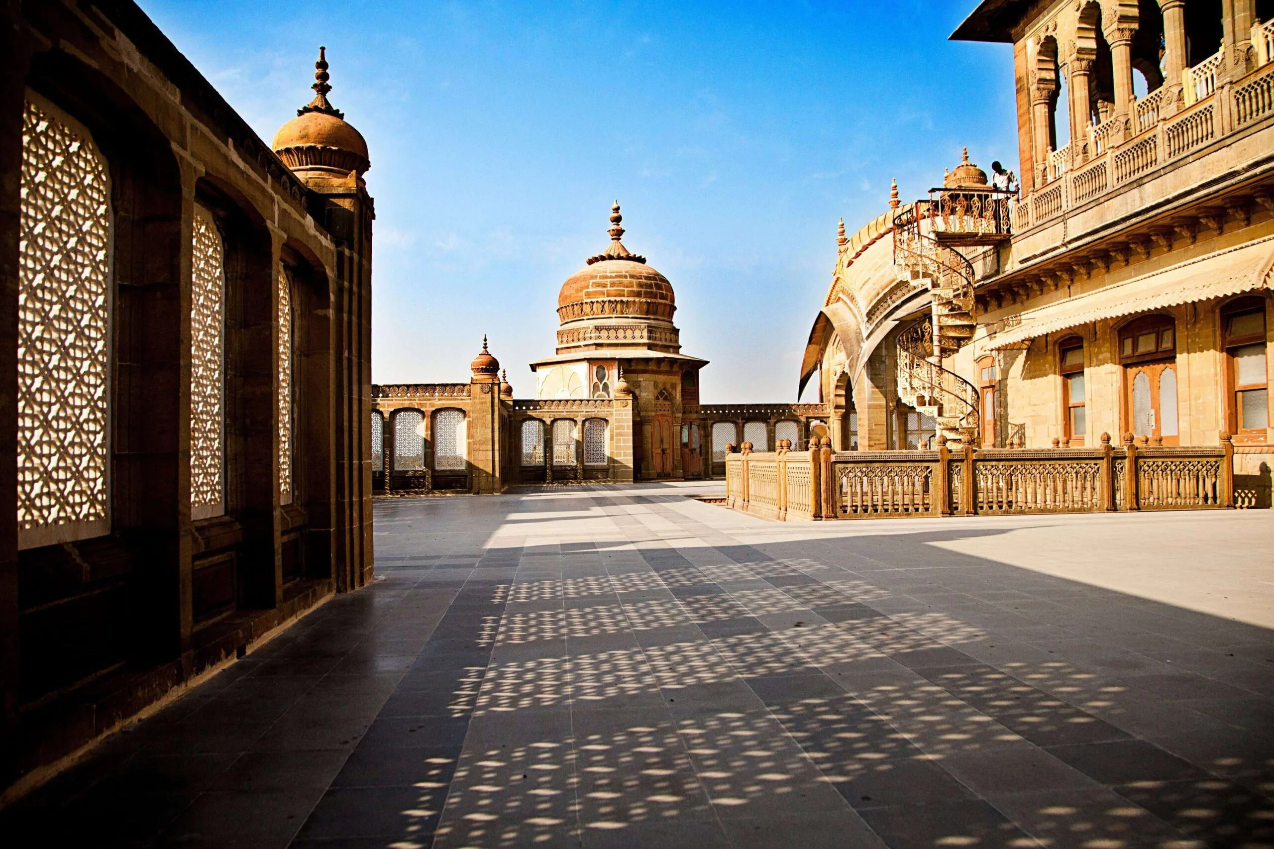 A stunning view of a palace courtyard showcasing intricate design and shadows.